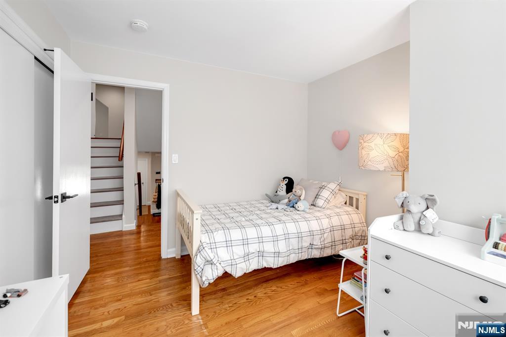 433 Piermont Road Cresskill, NJ 07626 - Photo 22 of 49 a bedroom with a bed and wooden floor