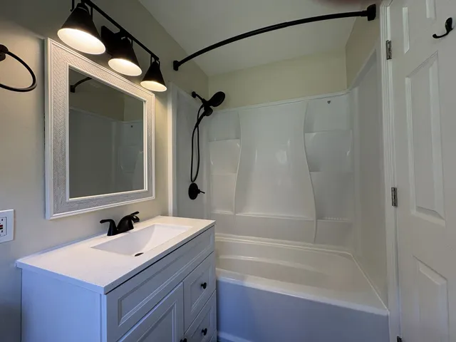 a bathroom with a sink mirror vanity and toilet