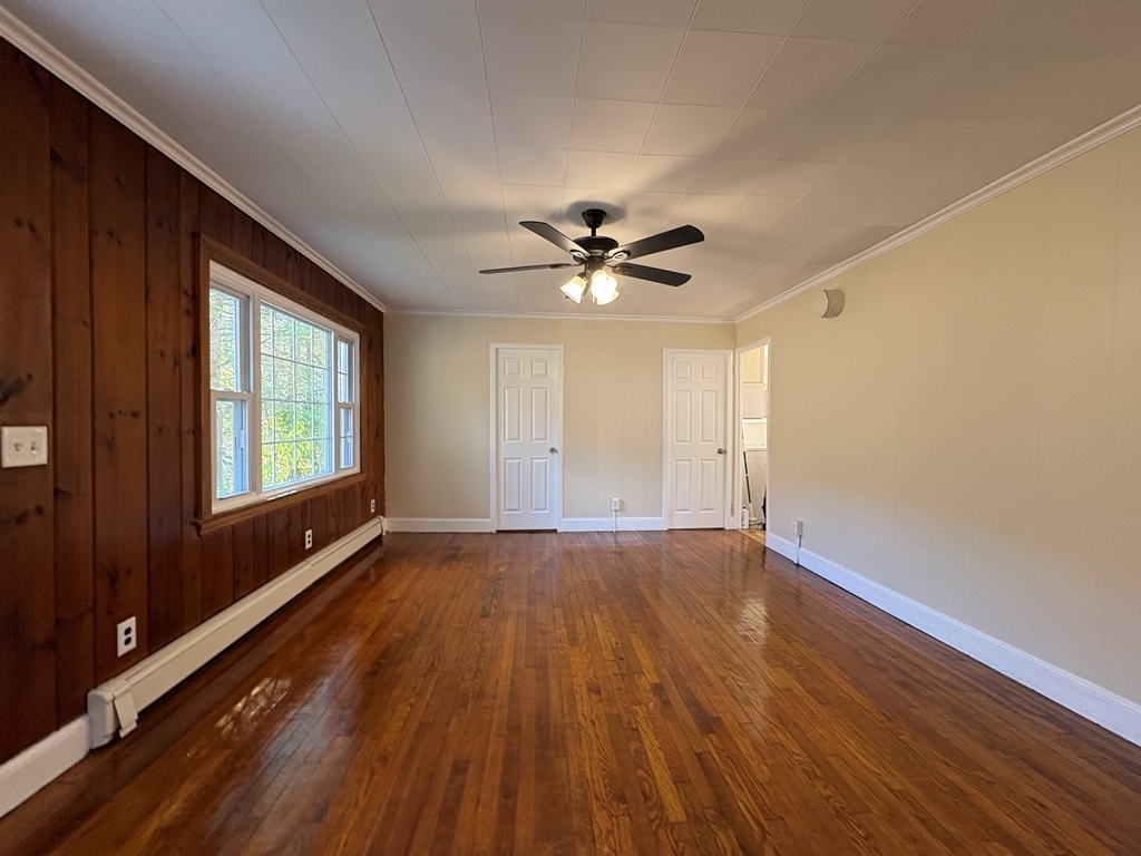 690 Greystone Road Plymouth, CT 06782 - Photo 3 of 16 a view of an empty room with a window and wooden floor