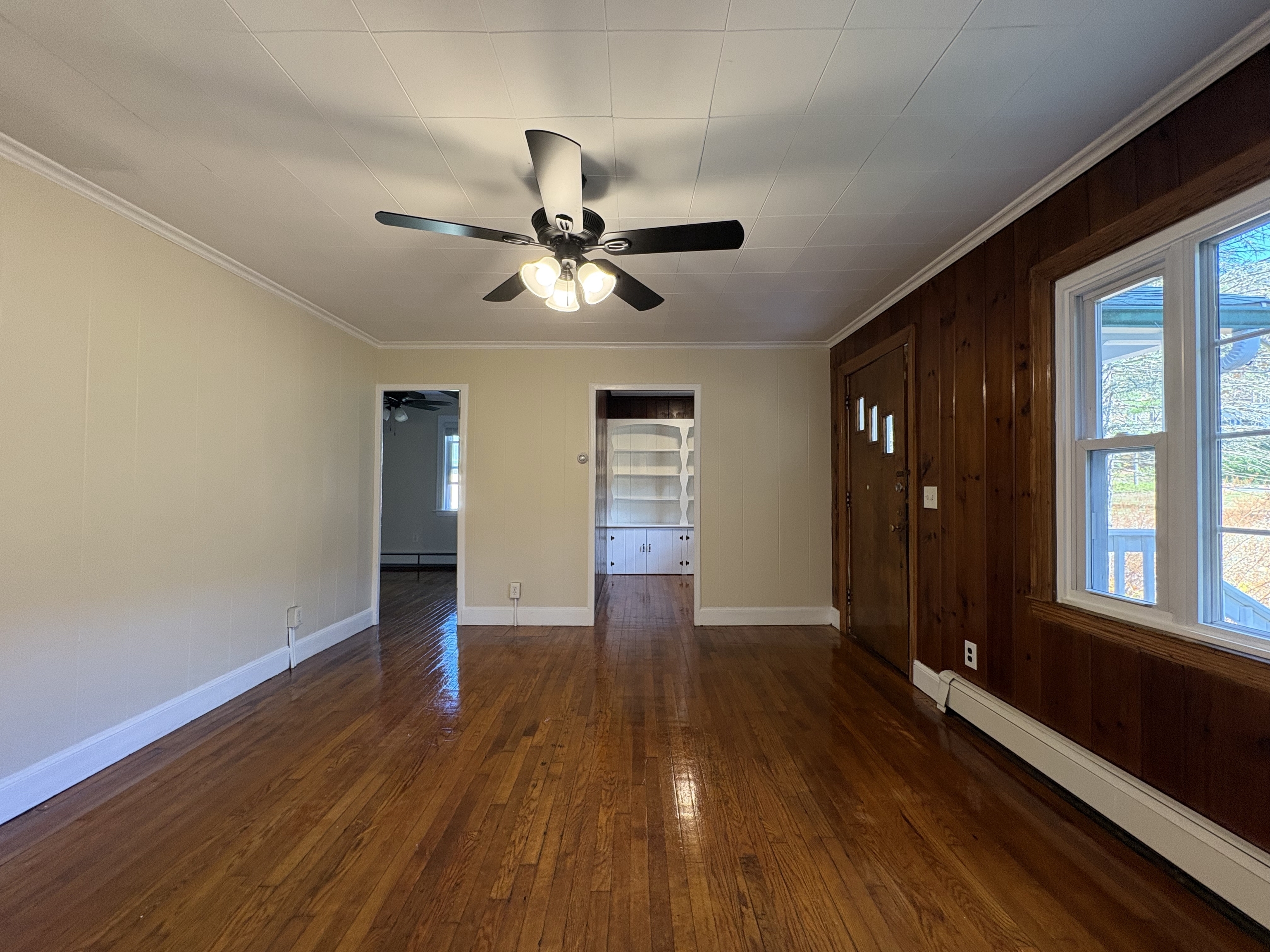 690 Greystone Road Plymouth, CT 06782 - Photo 4 of 16 a view of an empty room with wooden floor and a window