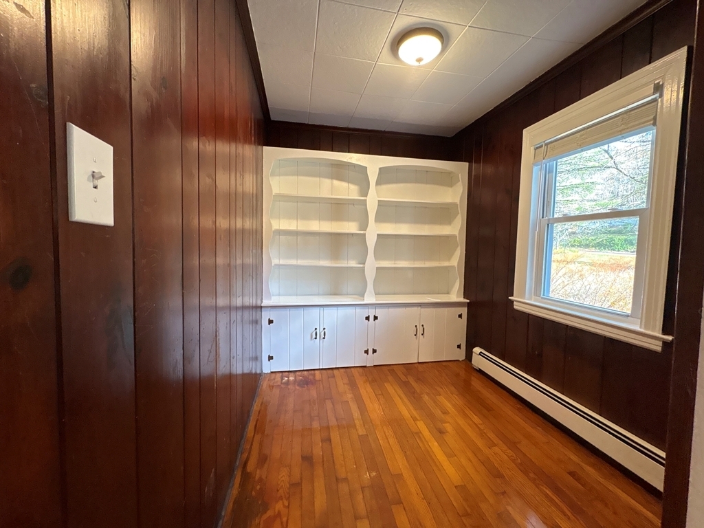 690 Greystone Road Plymouth, CT 06782 - Photo 5 of 16 an empty room with wooden floor and windows