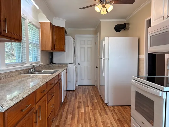 a kitchen with a sink stove and refrigerator