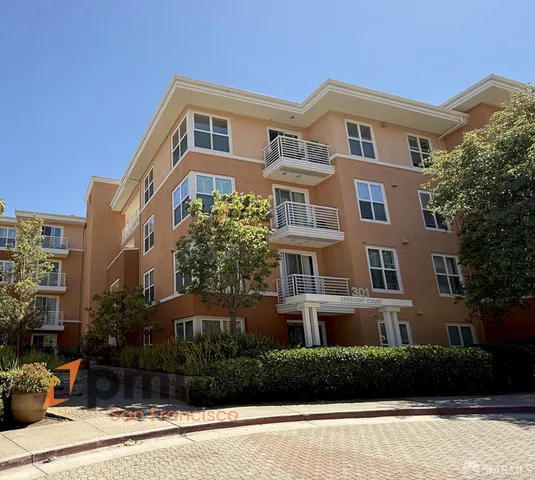 a front view of a residential apartment building with a yard