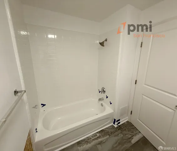a bathroom with a bathtub and a shower