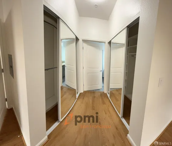 a view of hallway with wooden floor