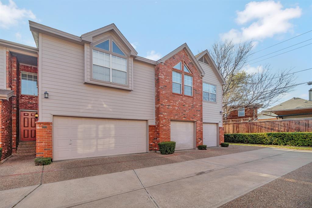 18240 Midway Road, Unit 1304 Dallas, TX 75287 - Photo 1 of 1 a front view of a house with a yard and garage