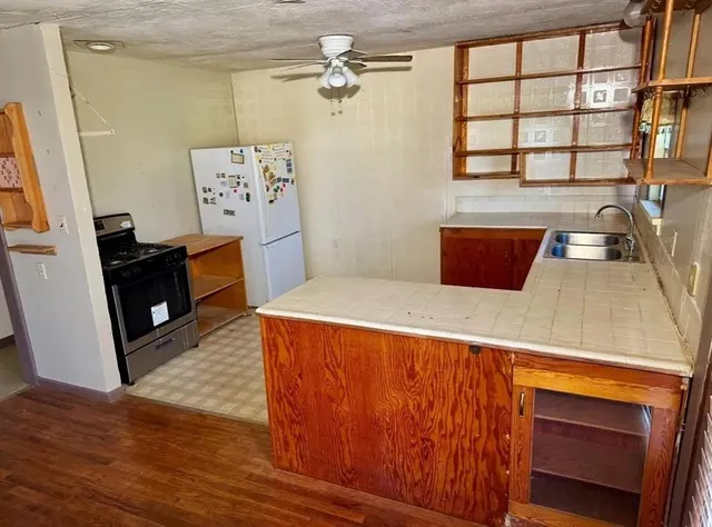 a kitchen with wooden cabinets and a stove