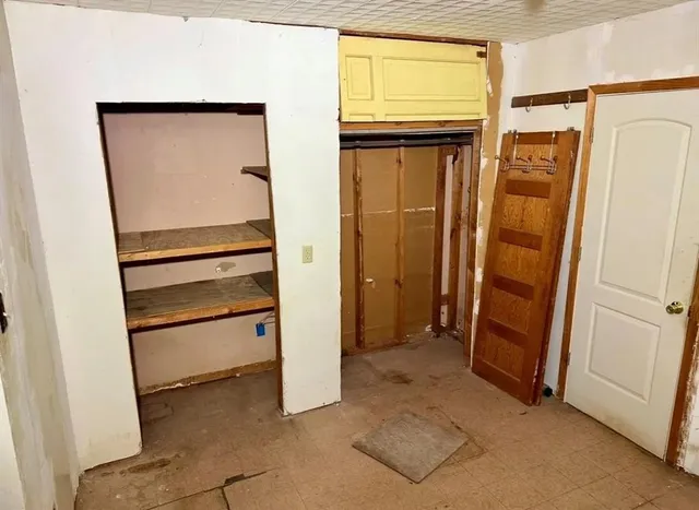 a view of walk in closet with empty room