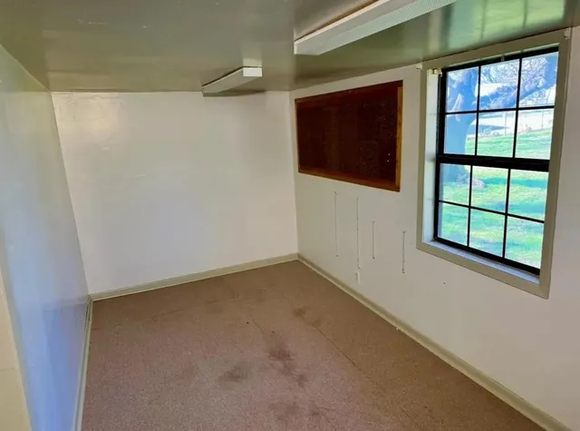 a view of an empty room with a window
