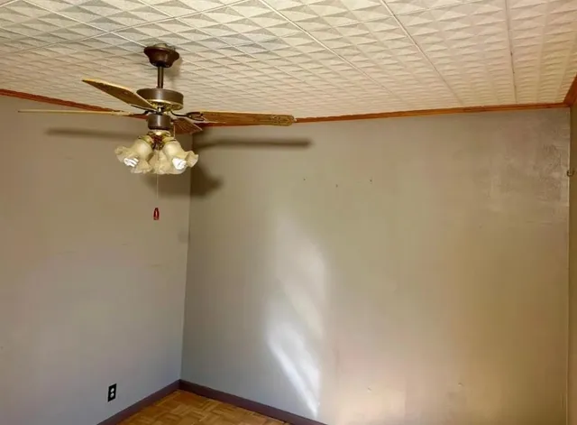 a view of a chandelier fan and wooden floor