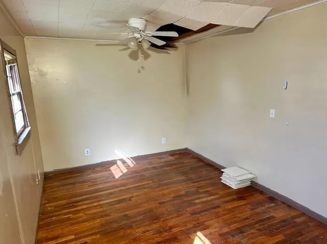 a view of a room with wooden floor and brick wall