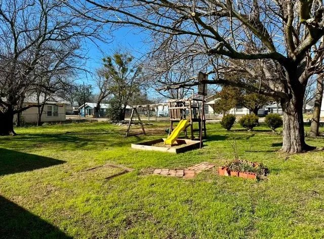 a view of a park with swings and slides