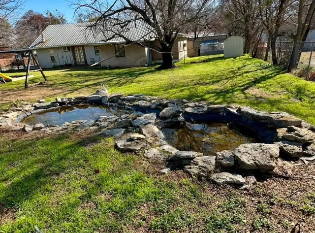 a view of a house with a yard covered with snow
