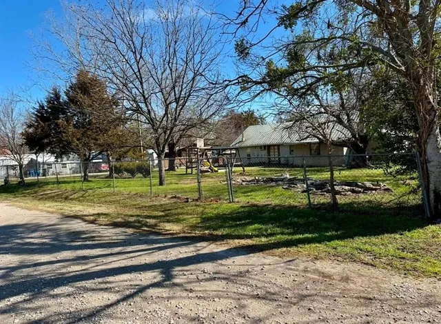 a view of a park with large trees