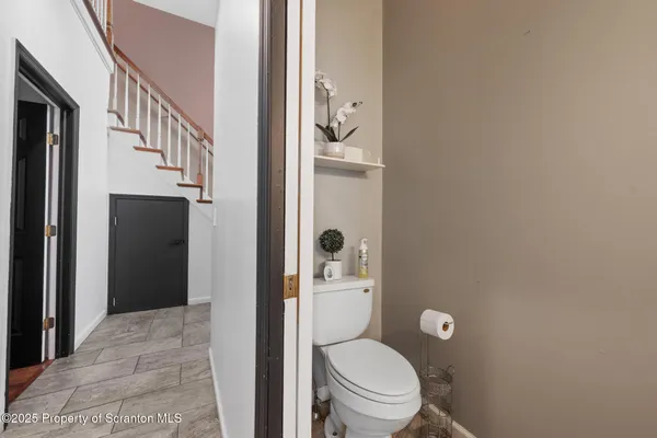 a bathroom with a granite countertop toilet and a shower