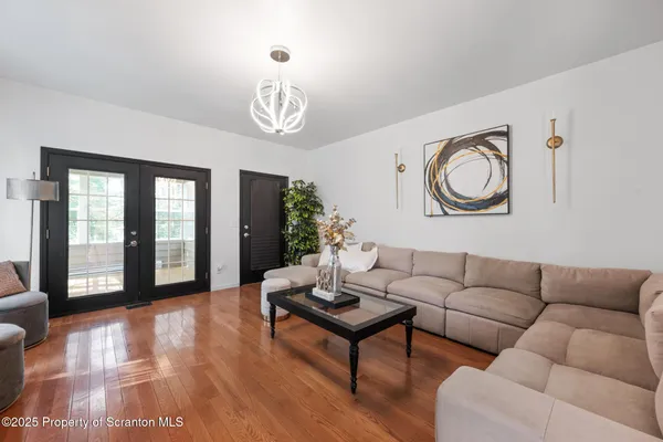 a living room with furniture and wooden floor