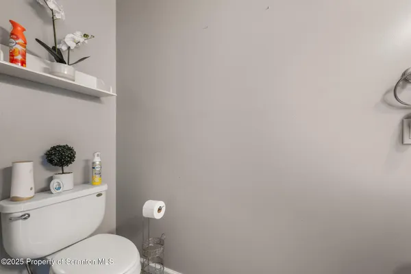 a white toilet sitting next to a bathroom sink