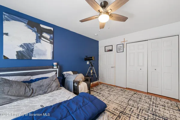 a bedroom with furniture and wooden floor