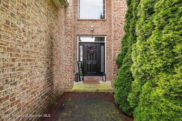 a view of a brick house with a small yard
