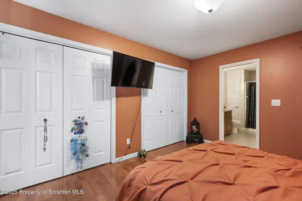 a bedroom with a bed and a walk in closet