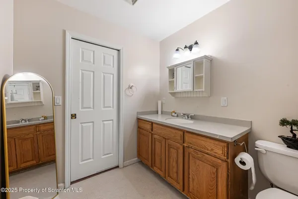 a bathroom with a sink toilet vanity and tub