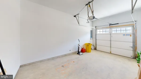 a kitchen with a refrigerator a stove and a dining table with wooden floor