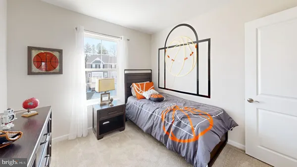 a bedroom with a bed and dresser with wooden floor