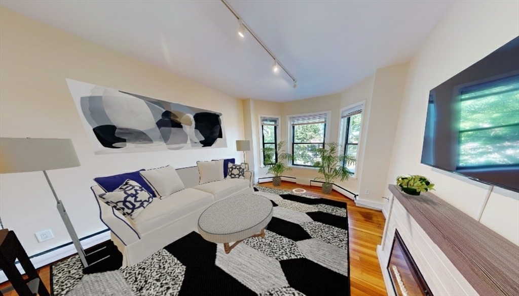 1238 Commonwealth Avenue, Unit 51 Boston, MA 02134 - Photo 2 of 10 a living room with furniture and a flat screen tv