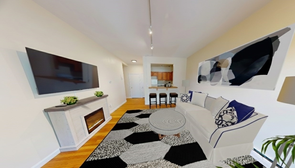 1238 Commonwealth Avenue, Unit 51 Boston, MA 02134 - Photo 3 of 10 a living room with furniture and a flat screen tv