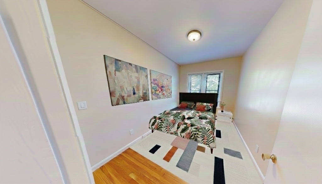 1238 Commonwealth Avenue, Unit 51 Boston, MA 02134 - Photo 7 of 10 a bed room with a bed and a window