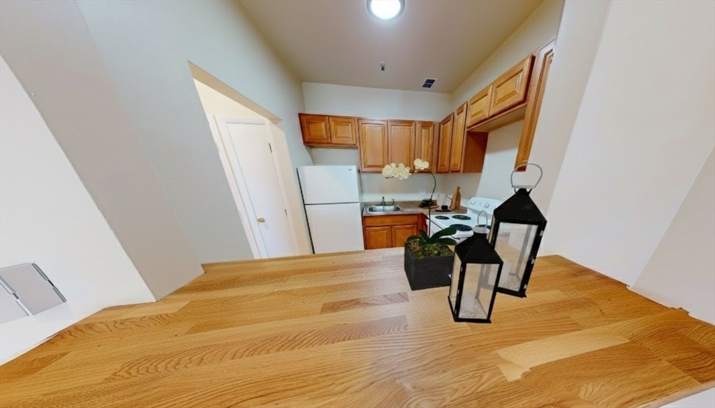 1238 Commonwealth Avenue, Unit 51 Boston, MA 02134 - Photo 9 of 10 a bed room with a bed and a chair