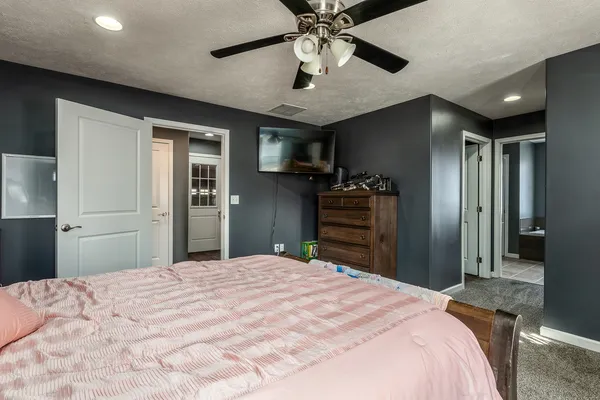 a bedroom with a bed and a chandelier