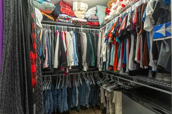 a view of walk in closet with clothes