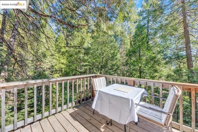 a view of a balcony with wooden floor and fence