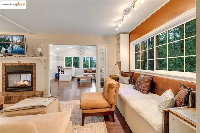 a living room with furniture a fireplace and window