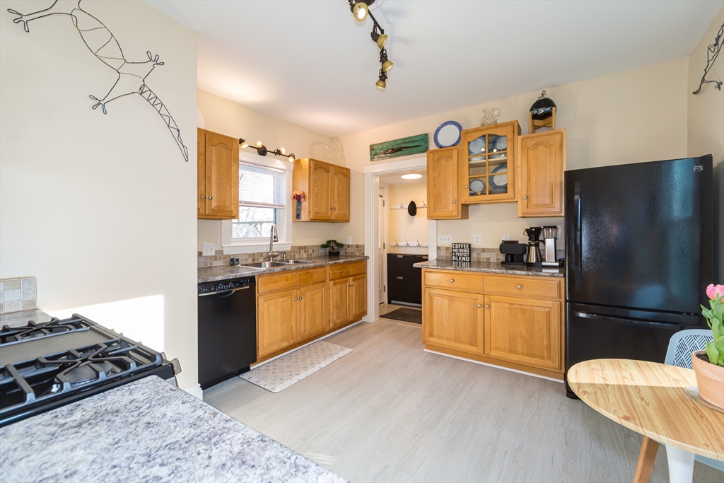 62 Central Street Framingham, MA 01701 - Photo 11 of 35 a kitchen with granite countertop stainless steel appliances and wooden cabinets