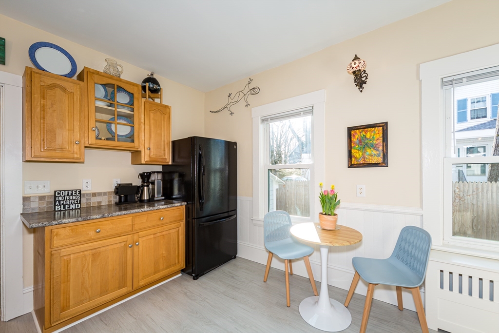 62 Central Street Framingham, MA 01701 - Photo 13 of 35 a kitchen with stainless steel appliances a refrigerator a stove a dining table and chairs