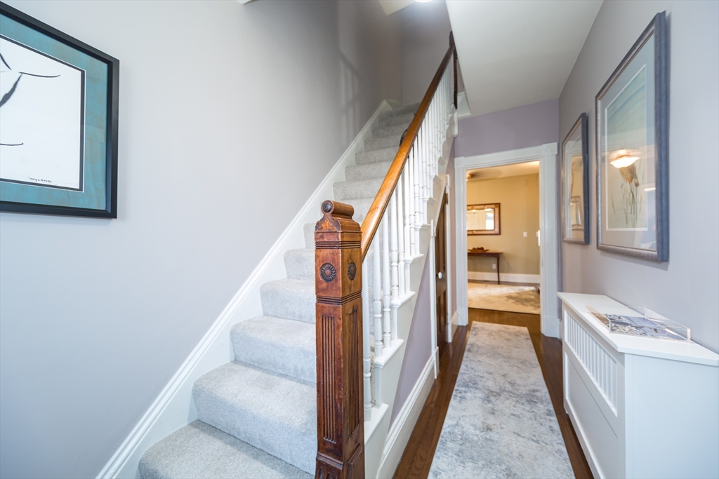 62 Central Street Framingham, MA 01701 - Photo 2 of 35 a view of a hallway with wooden floor and staircase