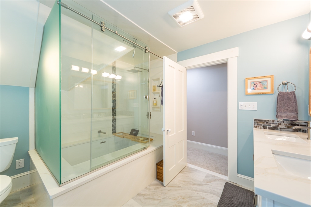 62 Central Street Framingham, MA 01701 - Photo 21 of 35 a bathroom with a granite countertop sink a mirror and a shower