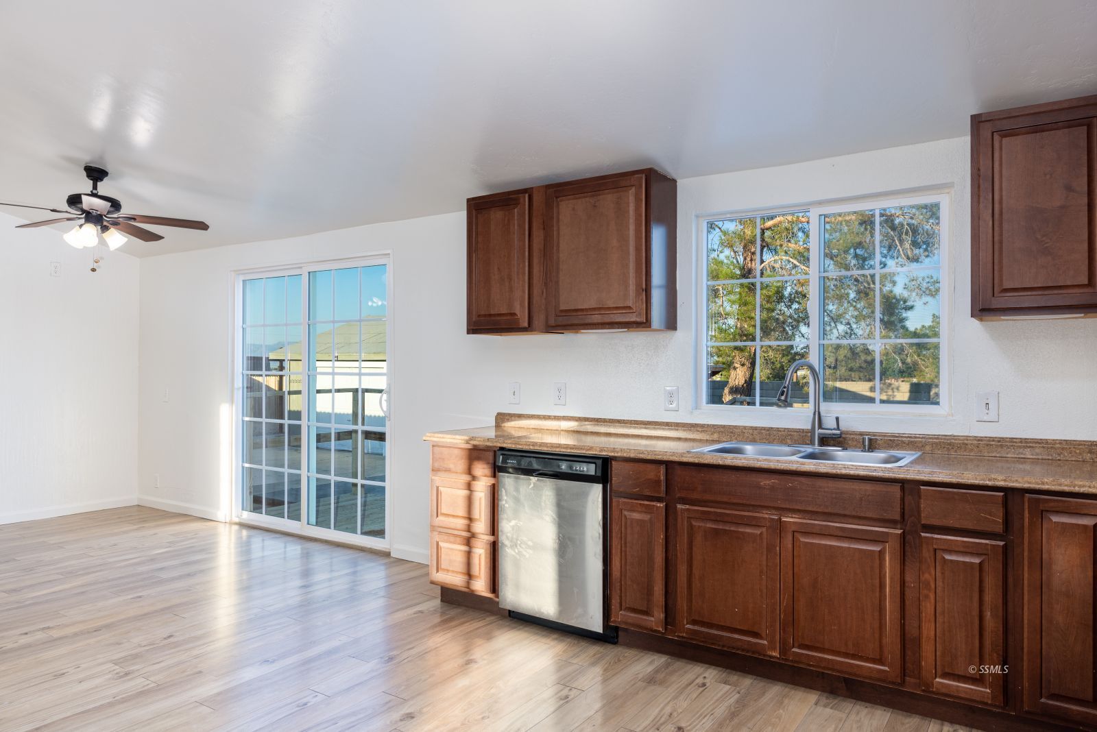 828 North Victor Street Ridgecrest, CA 93555 - Photo 13 of 50 a kitchen with stainless steel appliances granite countertop wooden floors and sink