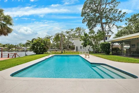 a view of swimming pool with outdoor seating and yard