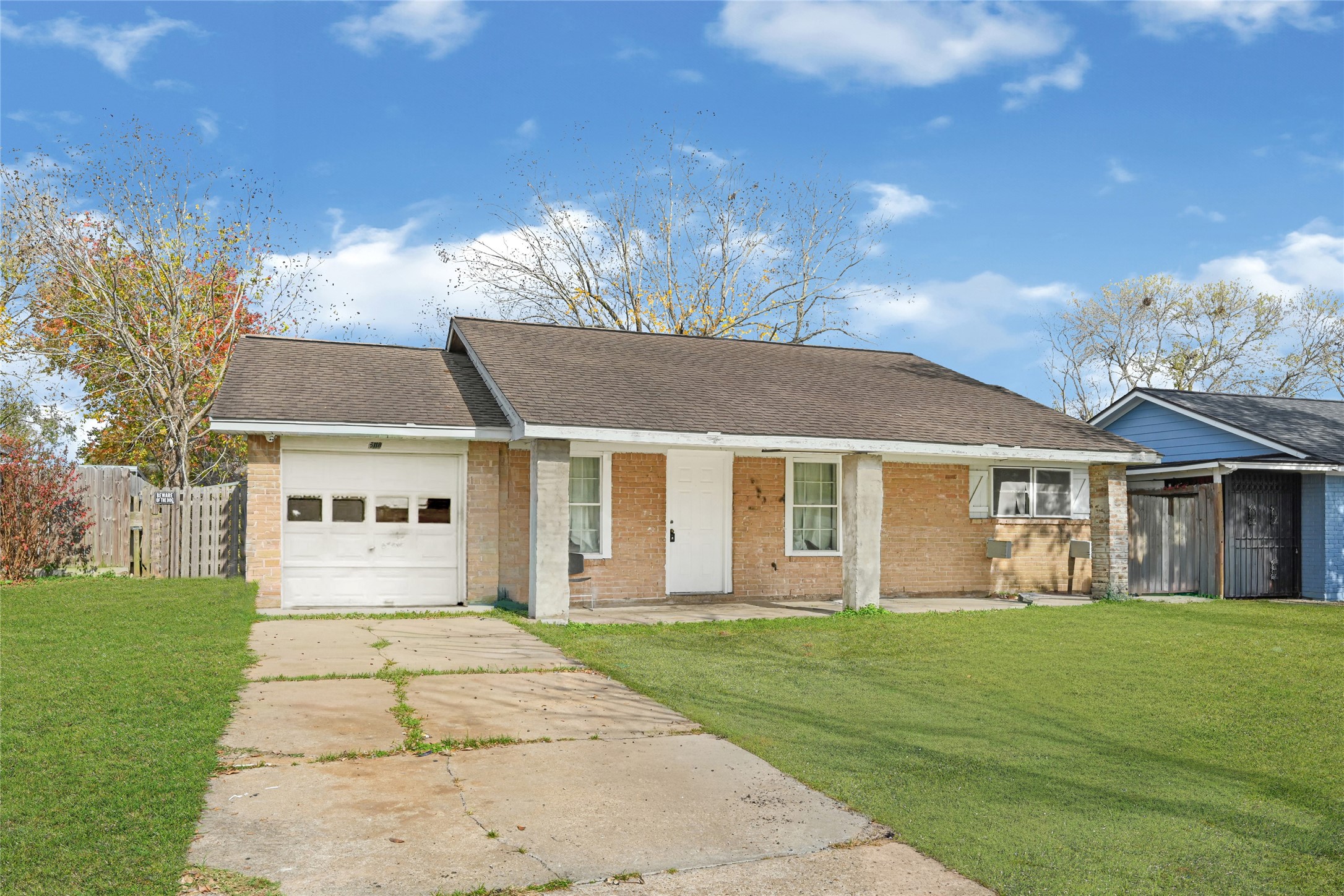 a front view of a house with a garden and trees