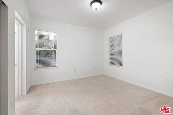 a bathroom with a sink a toilet a large mirror and shower