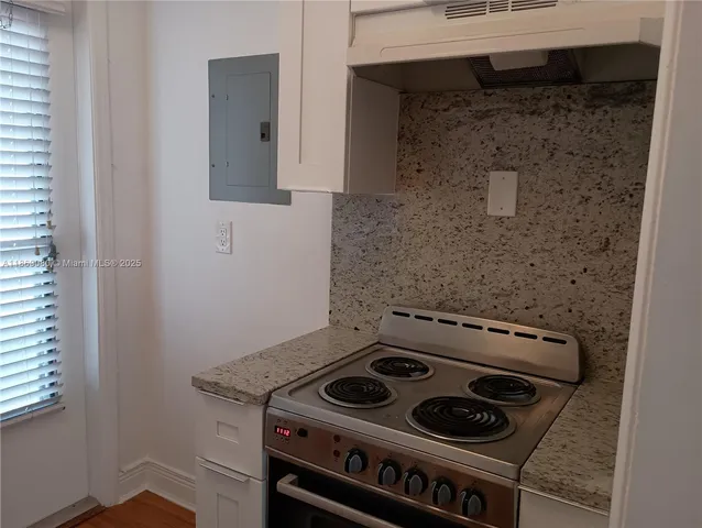 a stove top oven sitting inside of a kitchen
