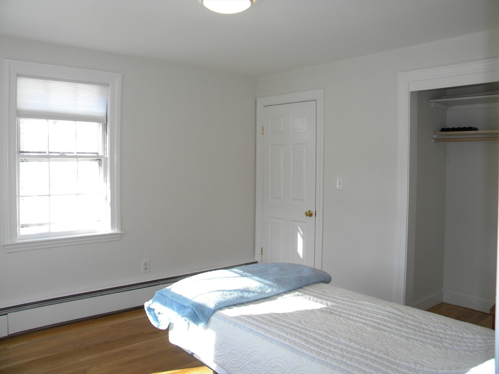 21 Lovers Lane Groton, MA 01450 - Photo 11 of 35 a bedroom with a bed and wooden floor