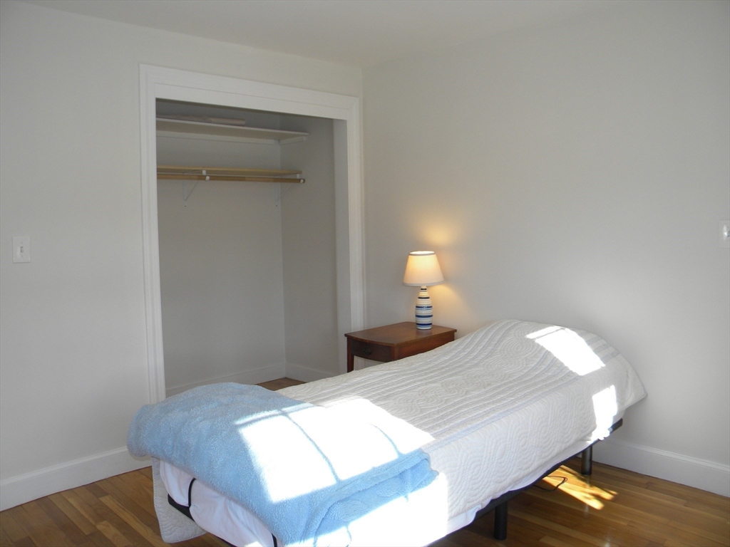 21 Lovers Lane Groton, MA 01450 - Photo 12 of 35 a bedroom with a bed and a lamp on desk