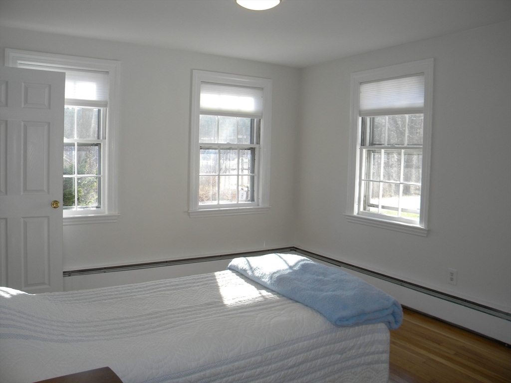 21 Lovers Lane Groton, MA 01450 - Photo 13 of 35 a view of empty room with wooden floor and fan
