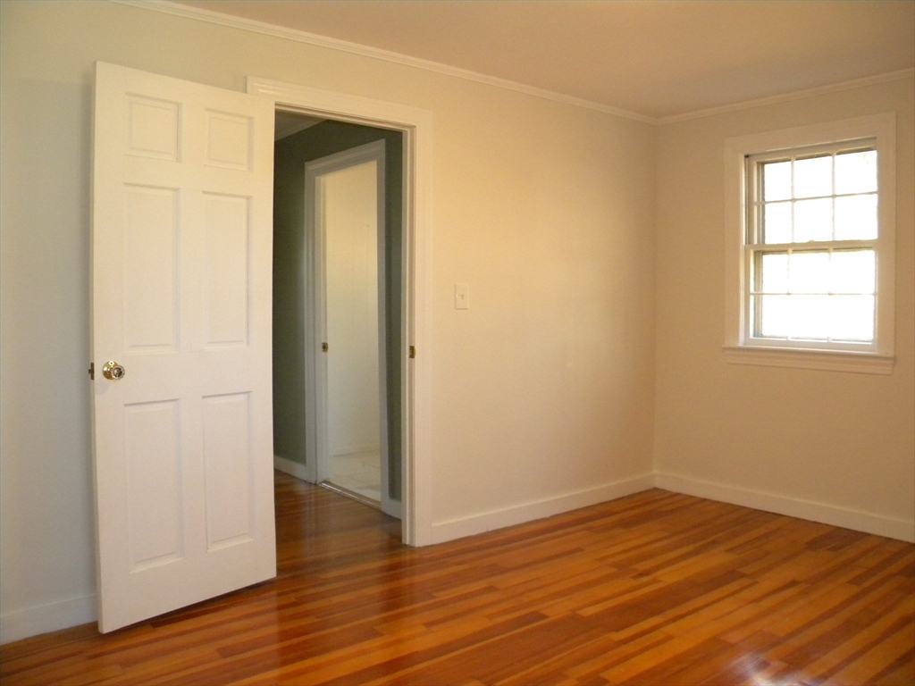 21 Lovers Lane Groton, MA 01450 - Photo 21 of 35 an empty room with wooden floor and a window