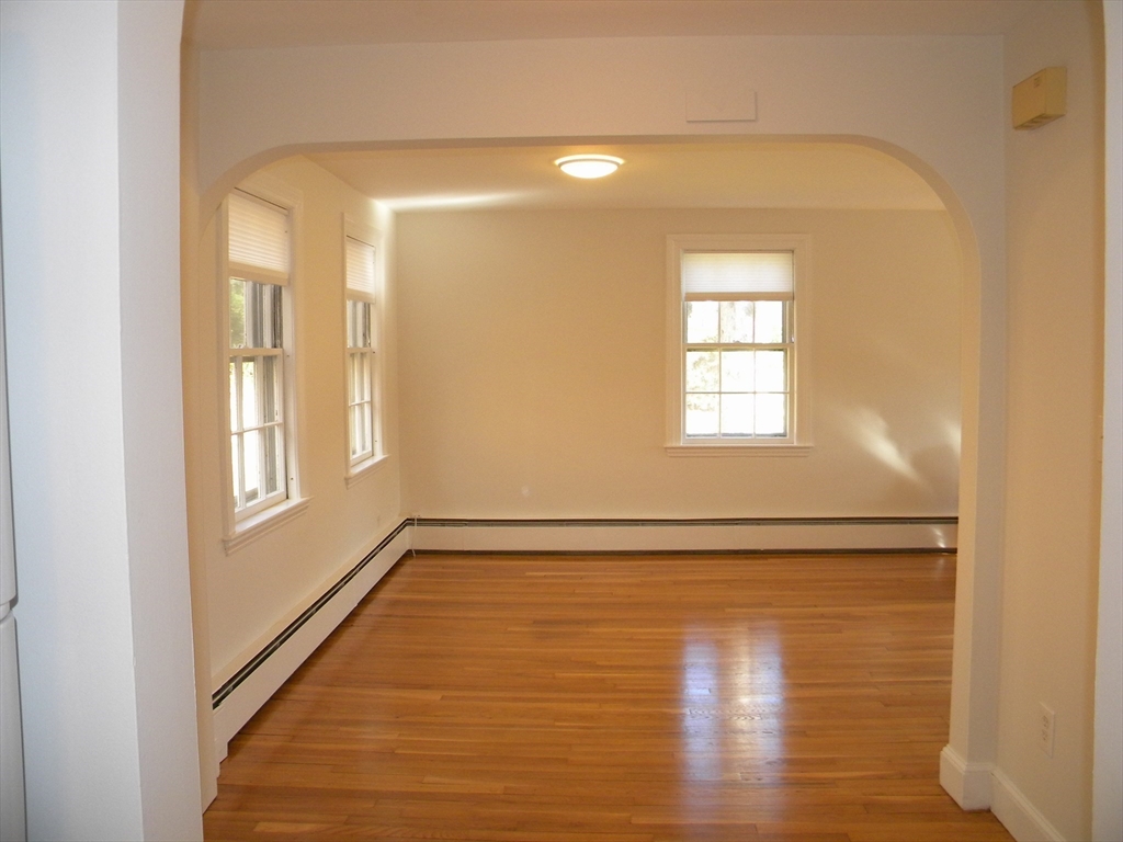 21 Lovers Lane Groton, MA 01450 - Photo 7 of 35 a view of an empty room with wooden floor and a window