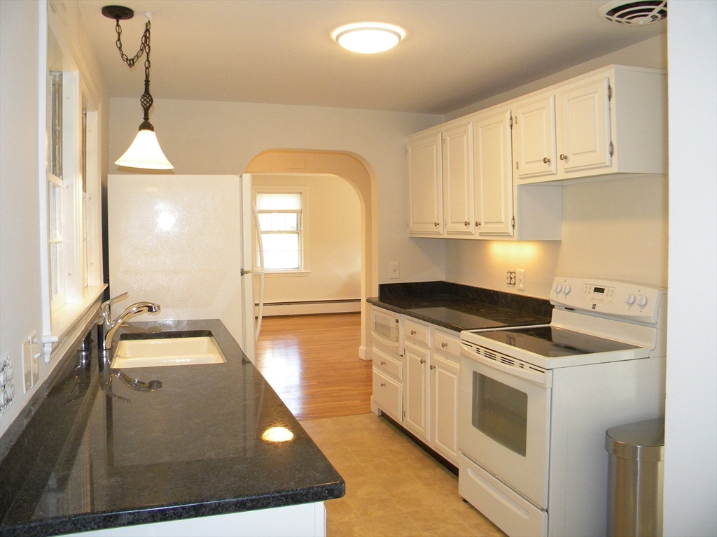 21 Lovers Lane Groton, MA 01450 - Photo 8 of 35 a kitchen that has a sink and a stove
